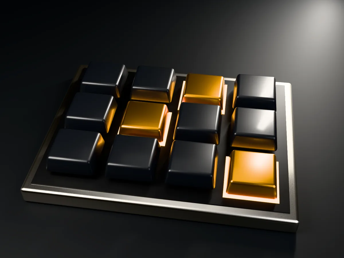 A machined keypad with graphite keys, three of them pressed down and lit amber from below
