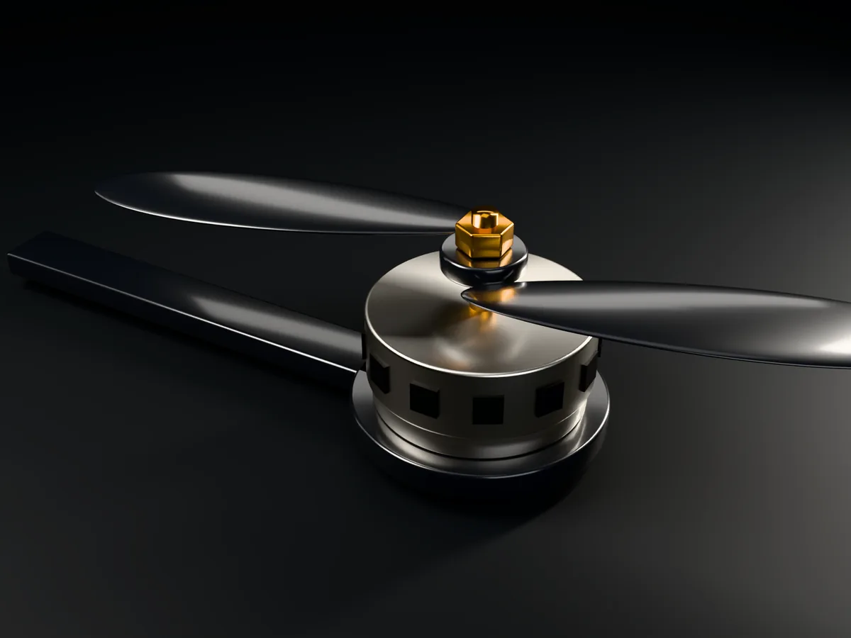 A machined drone motor with a carbon propeller and an amber nut, on a carbon arm