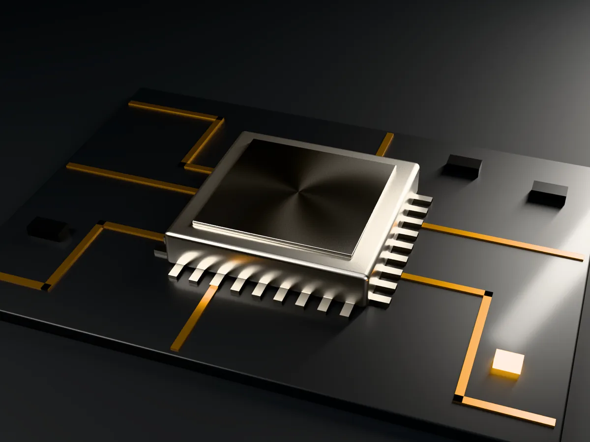A machined controller module on a dark circuit board, its traces lit amber